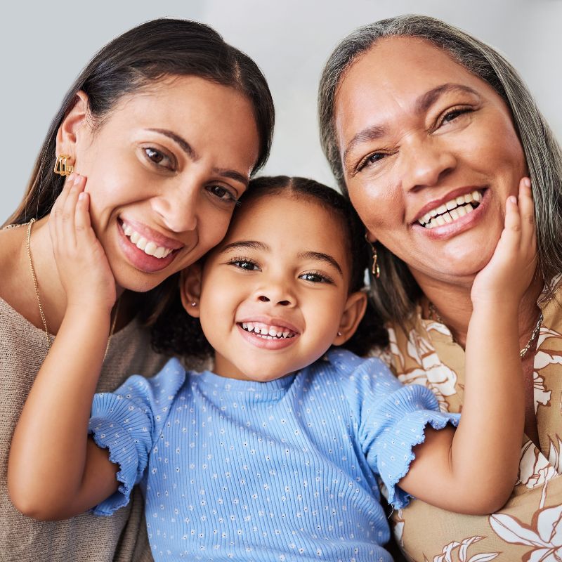 photo of an older woman, a young woman and a child smiling