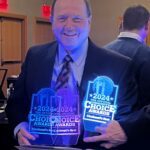 Photo of President Dan Applegate holding the three 2024 Community Choice Awards trophies while smiling