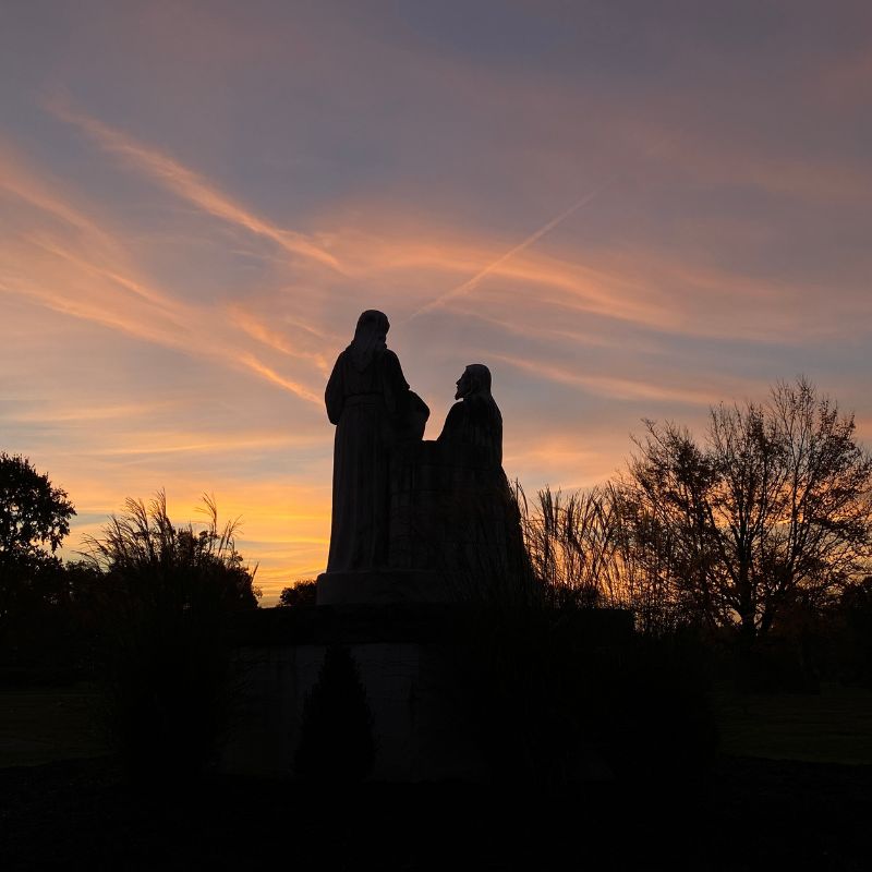 October photo by Alex Smrz of a sunset with a statue